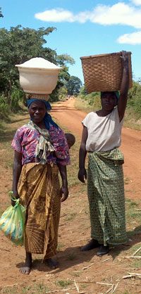 African Women Carrying Children and Loads Along Road, Malawi, Around 2000